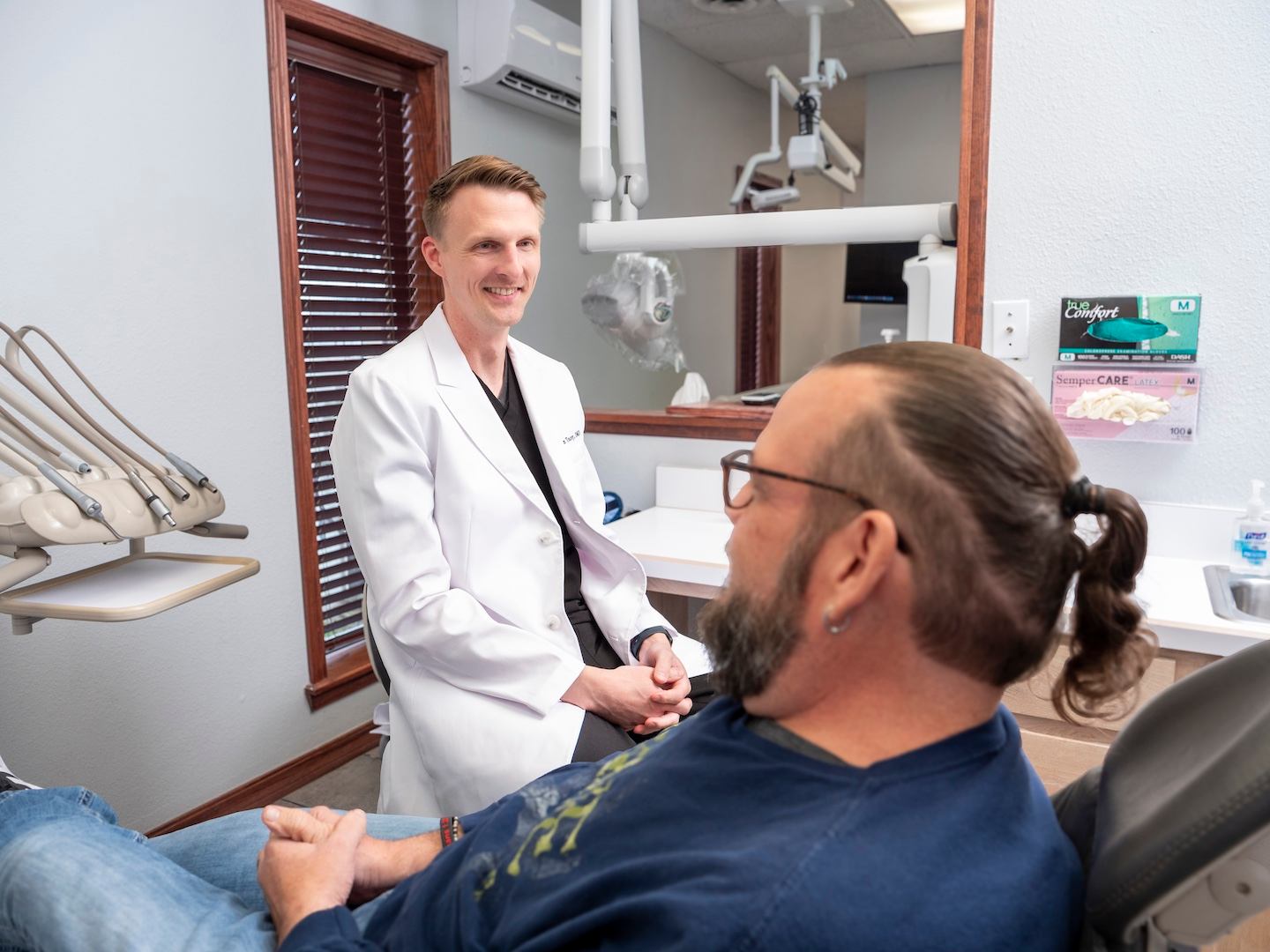 Dr. Tracey consulting a patient.